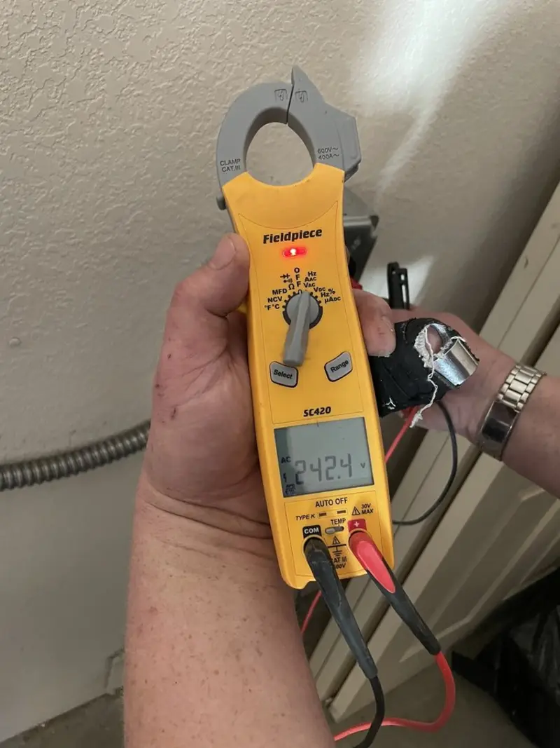 Voltage testing with clamp meter during Outlet Installation in Val Verde